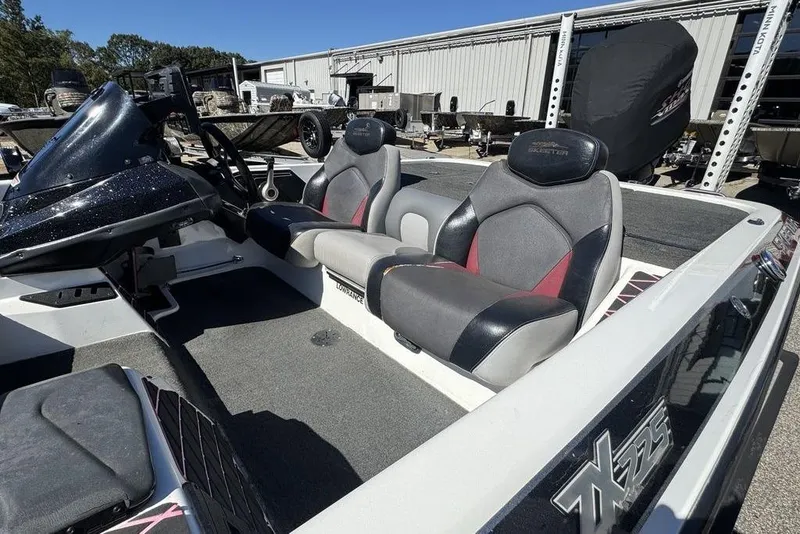 Slide: The Image of 2015 Skeeter ZX225 boat interior with dual seats and steering console. - 9