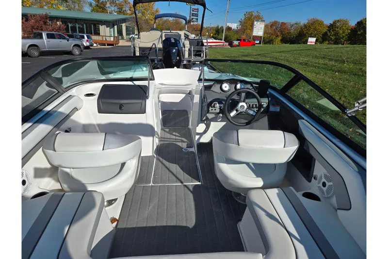 Slide: The Image of 2018 Yamaha Boats SX190 interior with white seating and modern dashboard. - 10