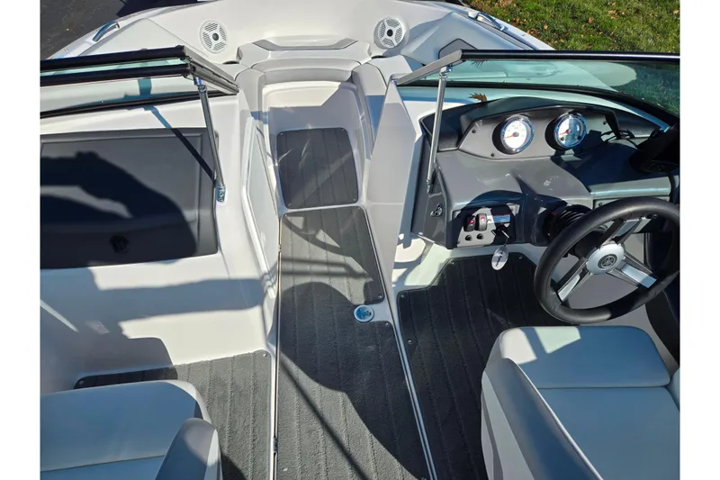 Slide: The Image of 2018 Yamaha Boats SX190 interior with steering wheel, dashboard, and seating. - 11