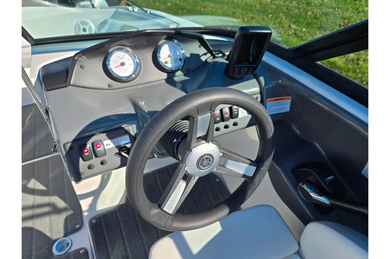 Slide: The Image of 2018 Yamaha Boats SX190 dashboard with steering wheel and control panel. - 12