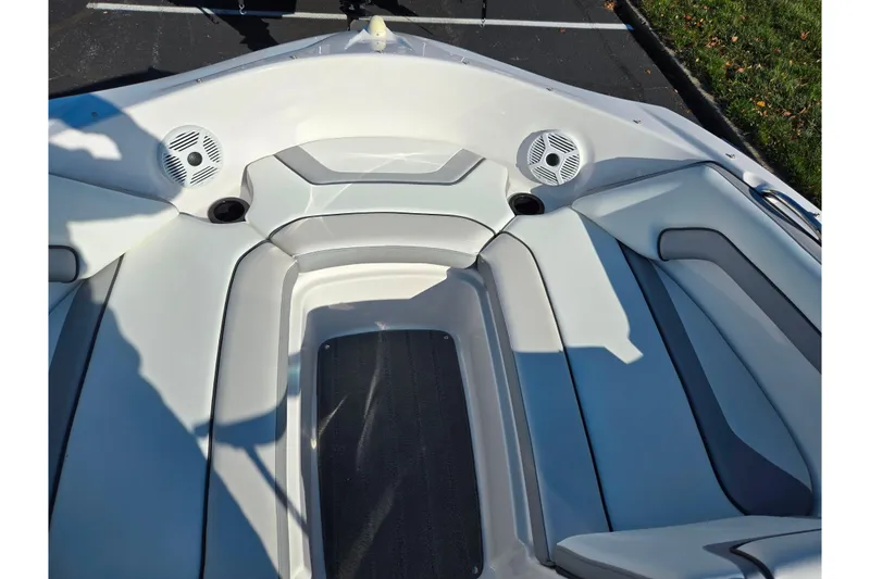 Slide: The Image of 2018 Yamaha Boats SX190 interior with cushioned seating and built-in speakers. - 17