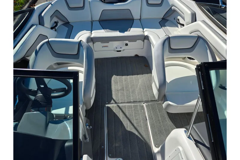 Slide: The Image of 2018 Yamaha Boats SX190 interior with gray seating and carpeted flooring. - 20