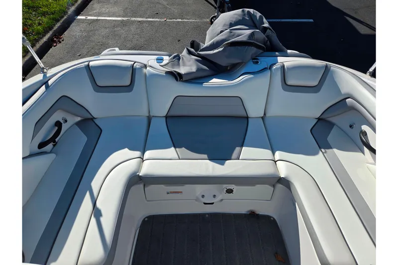 Slide: The Image of 2018 Yamaha Boats SX190 interior with gray seating and storage cover. - 21