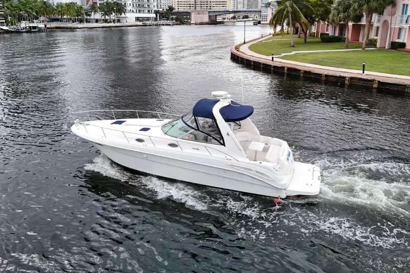 The Image of 1999 Sea Ray 340 boat cruising on a scenic waterway. - 0