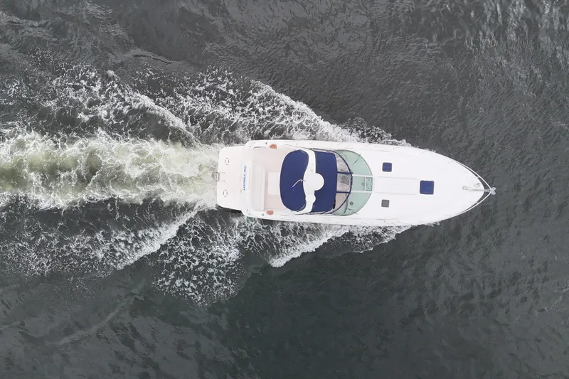 Slide: The Image of Overhead view of a 1999 Sea Ray 340 boat cruising on water. - 11
