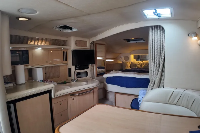 Slide: The Image of Interior of a 1999 Sea Ray 340 boat with cozy cabin and kitchenette. - 19