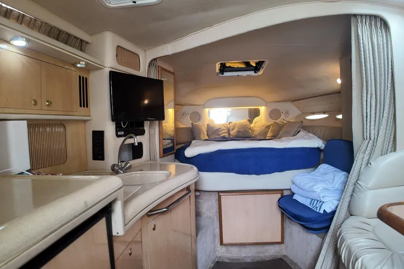 Slide: The Image of Interior of a 1999 Sea Ray 340 boat with cozy cabin and modern amenities. - 20