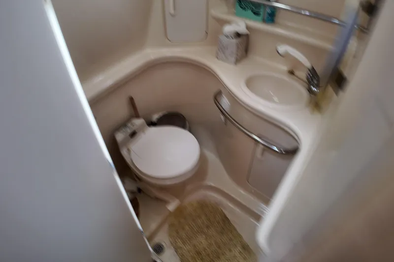 Slide: The Image of Compact bathroom in 1999 Sea Ray 340 boat with toilet and sink. - 25