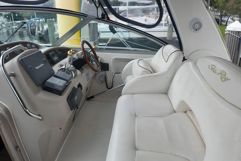 Slide: The Image of 1999 Sea Ray 340 boat interior with white seating and control panel. - 29