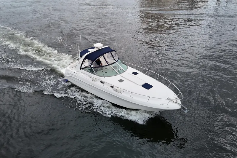 Slide: The Image of 1999 Sea Ray 340 boat cruising on open water, aerial view. - 3