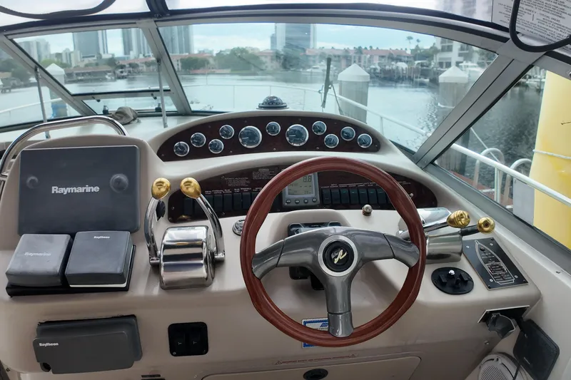 Slide: The Image of Cockpit of a 1999 Sea Ray 340 boat with steering wheel and navigation equipment. - 31