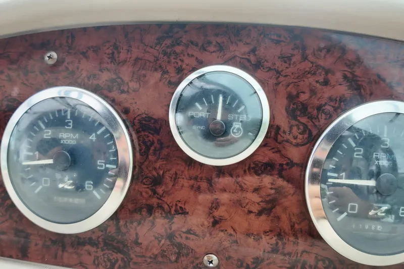 Slide: The Image of Dashboard of a 1999 Sea Ray 340 boat with RPM gauges. - 32
