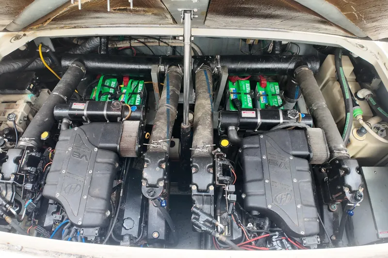 Slide: The Image of Engine compartment of a 1999 Sea Ray 340 boat, featuring dual engines and batteries. - 37