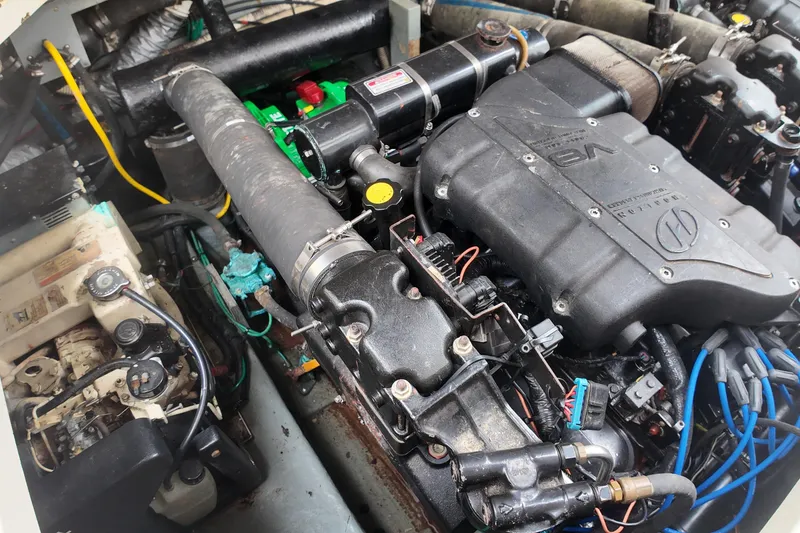Slide: The Image of Engine compartment of a 1999 Sea Ray 340 boat, showcasing detailed mechanical components. - 38
