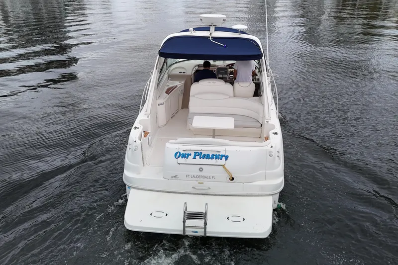 Slide: The Image of 1999 Sea Ray 340 boat cruising on calm water, rear view. - 6