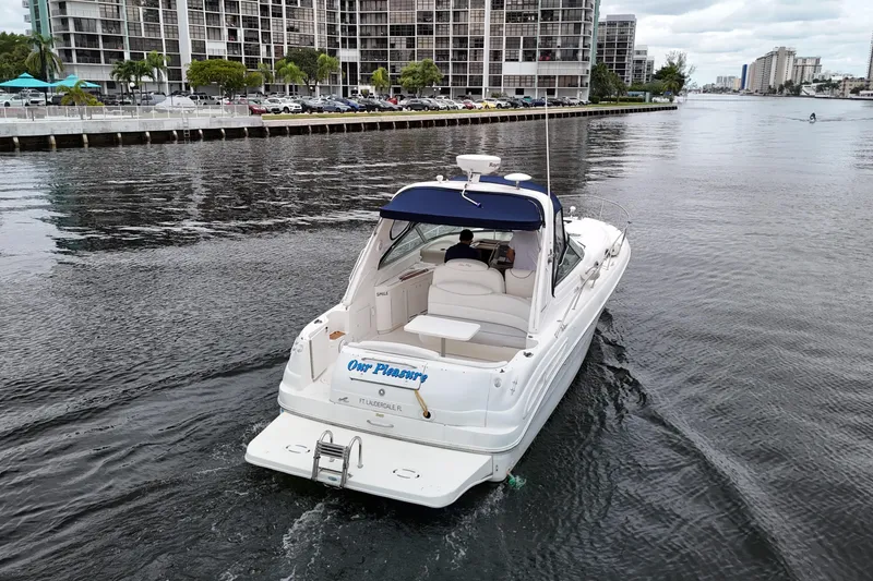 Slide: The Image of 1999 Sea Ray 340 boat cruising near waterfront buildings. - 7