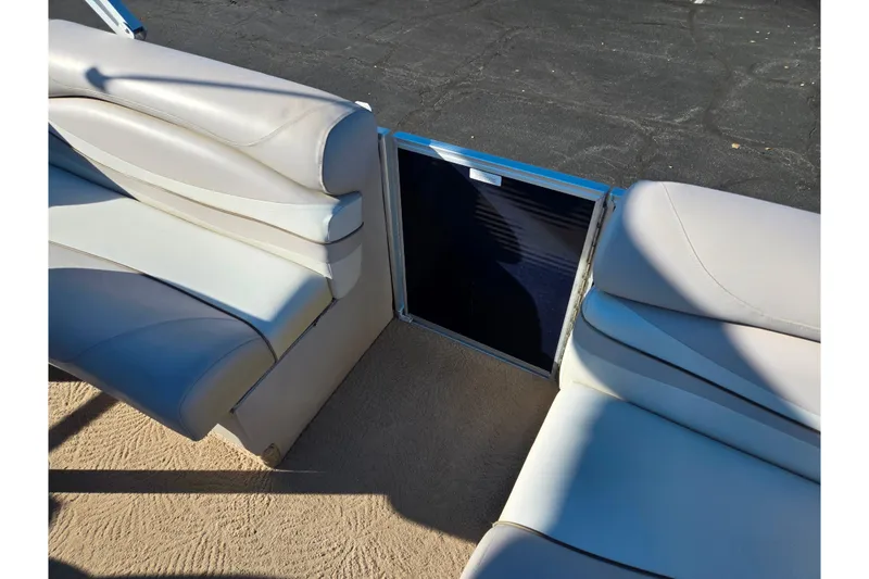 Slide: The Image of 2011 Bennington 2275RCW OB boat interior with beige seating and open gate. - 12