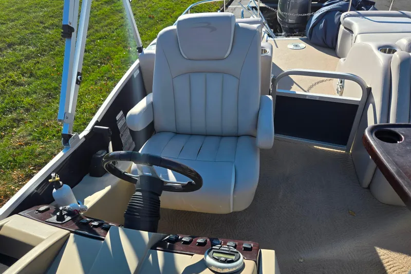 Slide: The Image of Captain's seat and helm of 2011 Bennington 2275RCW OB boat, featuring steering wheel and controls. - 13