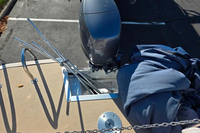 Slide: The Image of 2011 Bennington 2275RCW OB boat with outboard motor and cover, parked on asphalt. - 16