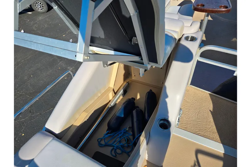 Slide: The Image of 2011 Bennington 2275RCW OB boat storage compartment with fenders and rope. - 20