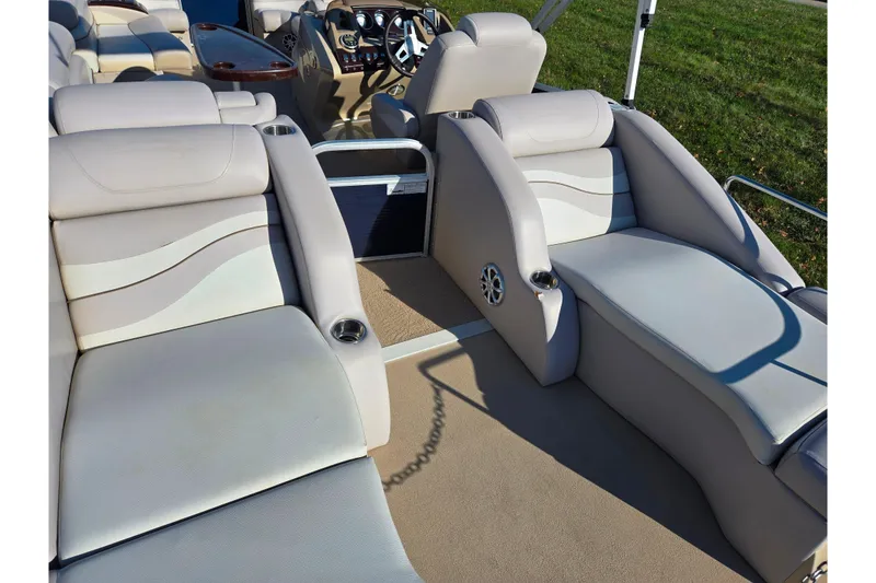 Slide: The Image of Luxurious seating on 2011 Bennington 2275RCW OB pontoon boat, featuring plush upholstery and cup holders. - 21