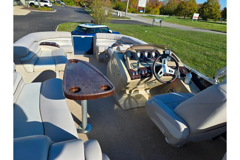Slide: The Image of 2011 Bennington 2275RCW OB pontoon boat interior with plush seating and modern dashboard. - 22