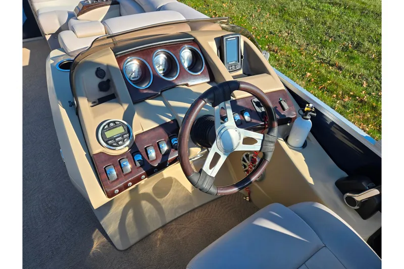 Slide: The Image of 2011 Bennington 2275RCW OB boat dashboard with steering wheel and control panel. - 23