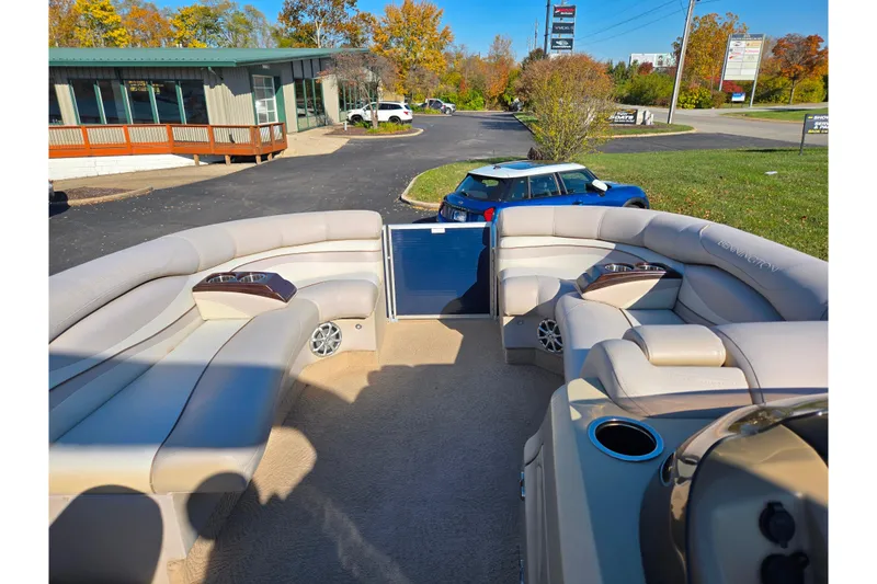 Slide: The Image of 2011 Bennington 2275RCW OB pontoon boat interior with plush seating and cup holders. - 25