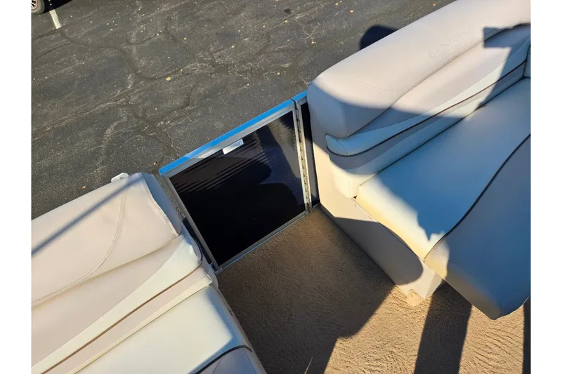 Slide: The Image of 2011 Bennington 2275RCW OB boat interior with beige seating and open gate. - 26