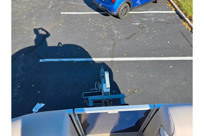 Slide: The Image of 2011 Bennington 2275RCW OB boat trailer in parking lot, shadow visible. - 27