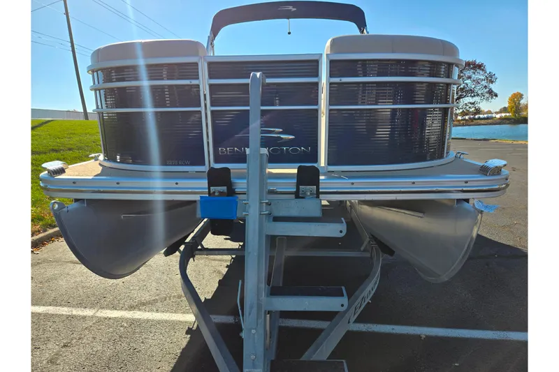 Slide: The Image of 2011 Bennington 2275RCW OB pontoon boat on trailer, parked near a lake. - 6
