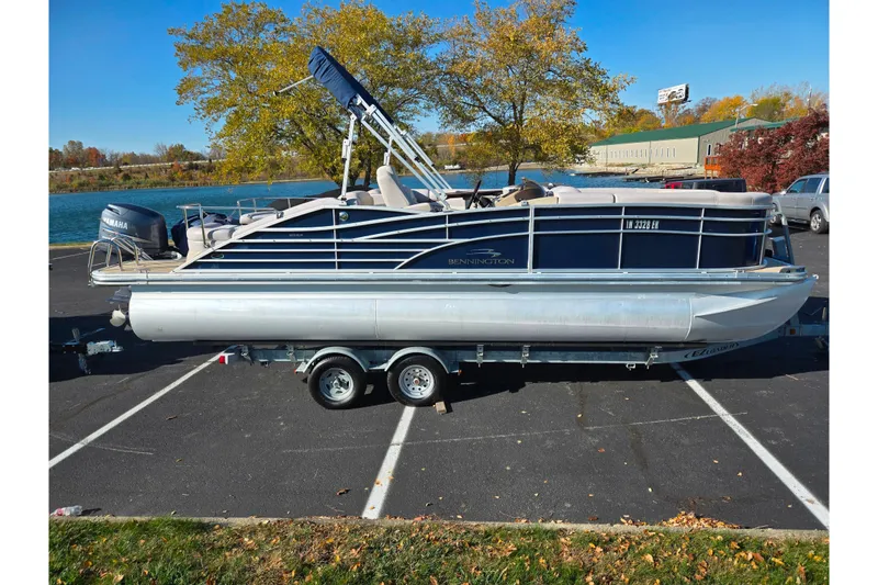 Slide: The Image of 2011 Bennington 2275RCW OB pontoon boat on trailer in parking lot. - 9