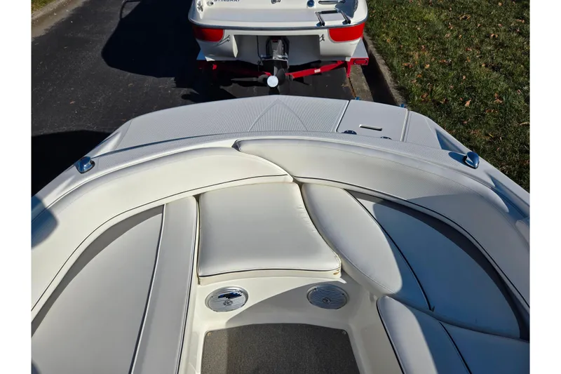 Slide: The Image of 2011 Bayliner 197 boat interior with white seating and trailer in background. - 15