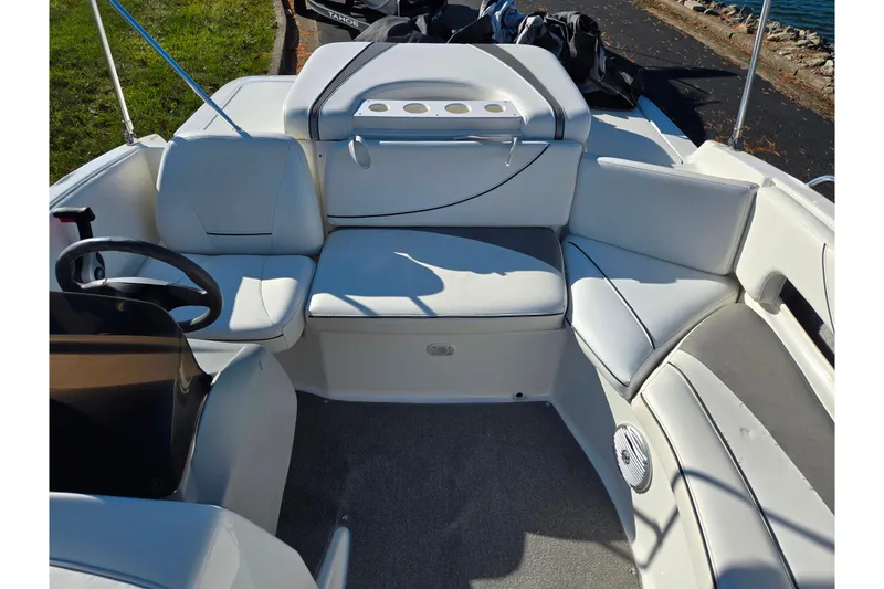 Slide: The Image of 2011 Bayliner 197 boat interior with white seating and steering wheel. - 18