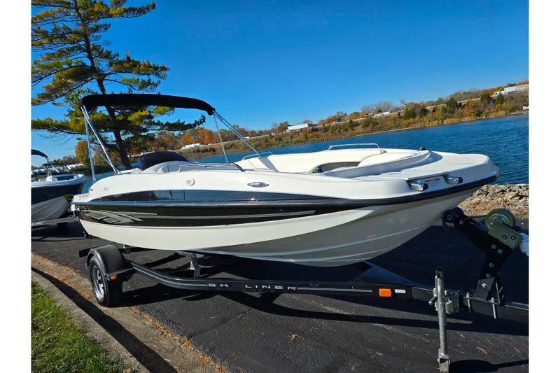 Slide: The Image of 2011 Bayliner 197 boat on trailer by a scenic lake. - 8