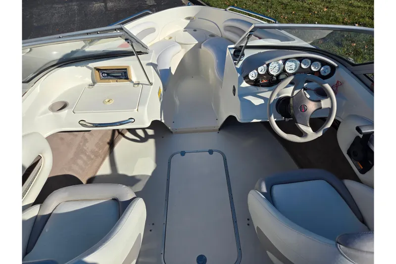 Slide: The Image of 2005 Stingray 195 LR boat interior with steering wheel, dashboard, and seating. - 11