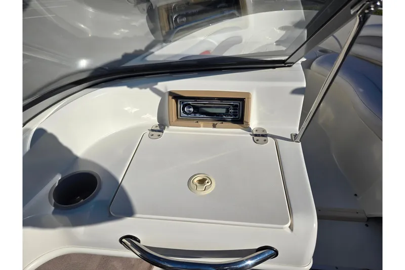Slide: The Image of 2005 Stingray 195 LR boat interior with stereo system and storage compartment. - 12