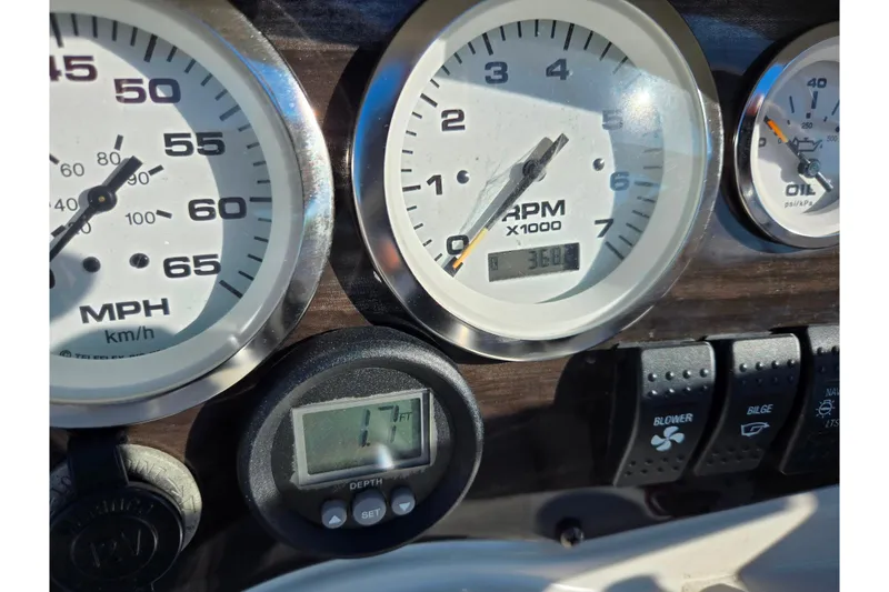 Slide: The Image of Dashboard of a 2005 Stingray 195 LR boat showing speedometer, RPM, and depth gauge. - 15