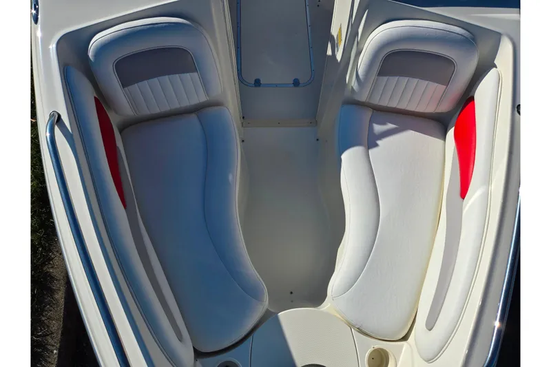 Slide: The Image of 2005 Stingray 195 LR boat interior with white and red cushioned seating. - 18