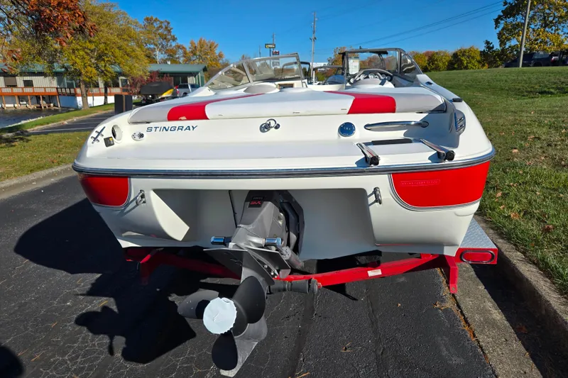 Slide: The Image of 2005 Stingray 195 LR boat on trailer, rear view, outdoors on sunny day. - 2