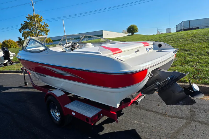 Slide: The Image of 2005 Stingray 195 LR boat on trailer, white and red design, parked outdoors. - 3