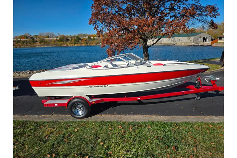 Slide: The Image of 2005 Stingray 195 LR boat on trailer by a lake, autumn scenery. - 9