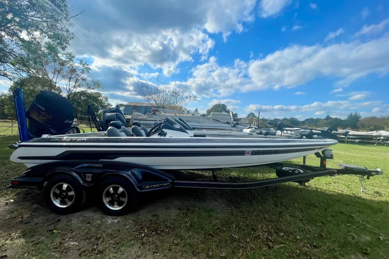 Slide: The Image of 2013 Skeeter FX21 bass boat on trailer under a blue sky. - 1