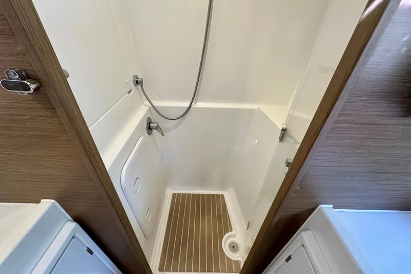 Slide: The Image of Shower area in 2020 Lagoon 42 catamaran with wooden flooring and modern fixtures. - 11