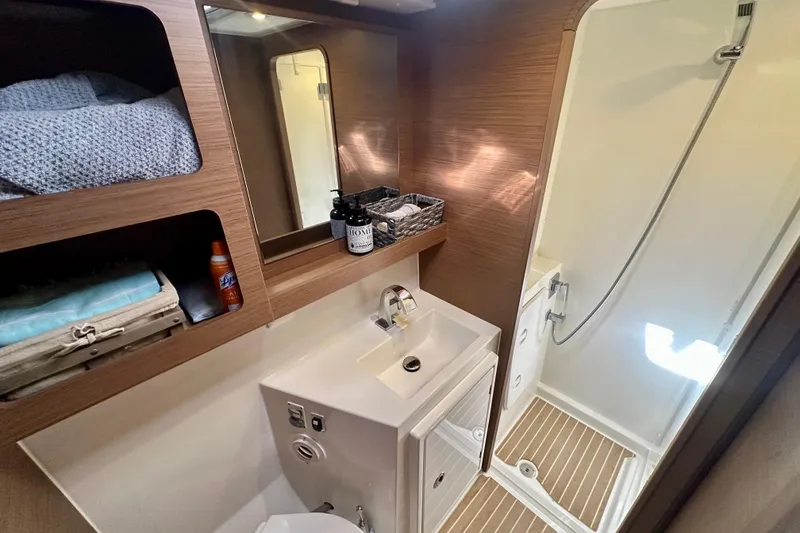 Slide: The Image of Modern bathroom in 2020 Lagoon 42 yacht with shower and wooden accents. - 12