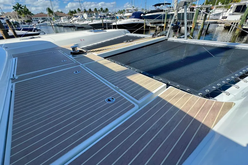 Slide: The Image of Deck of 2020 Lagoon 42 catamaran with wooden finish at marina. - 2