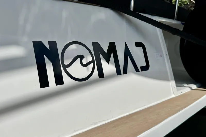 Slide: The Image of "Nomad" logo on 2020 Lagoon 42 catamaran, featuring sleek design and modern aesthetics. - 22