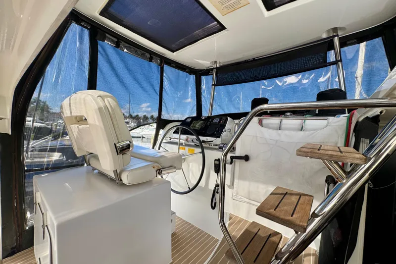Slide: The Image of Interior view of 2020 Lagoon 42 yacht helm with modern controls and seating. - 7