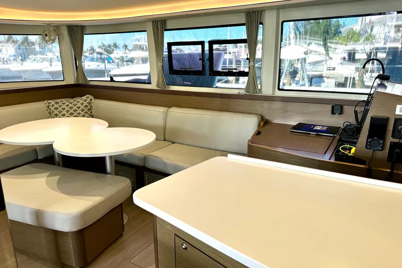 Slide: The Image of Interior of 2020 Lagoon 42 catamaran with modern seating and navigation equipment. - 8