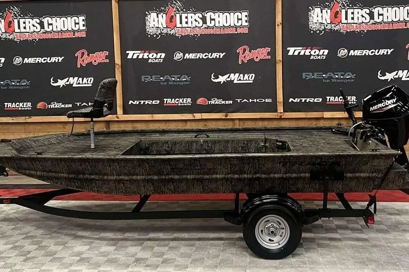 Slide: The Image of 2026 Tracker Grizzly 1654 Sportsman boat with camouflage design and Mercury outboard motor. - 3